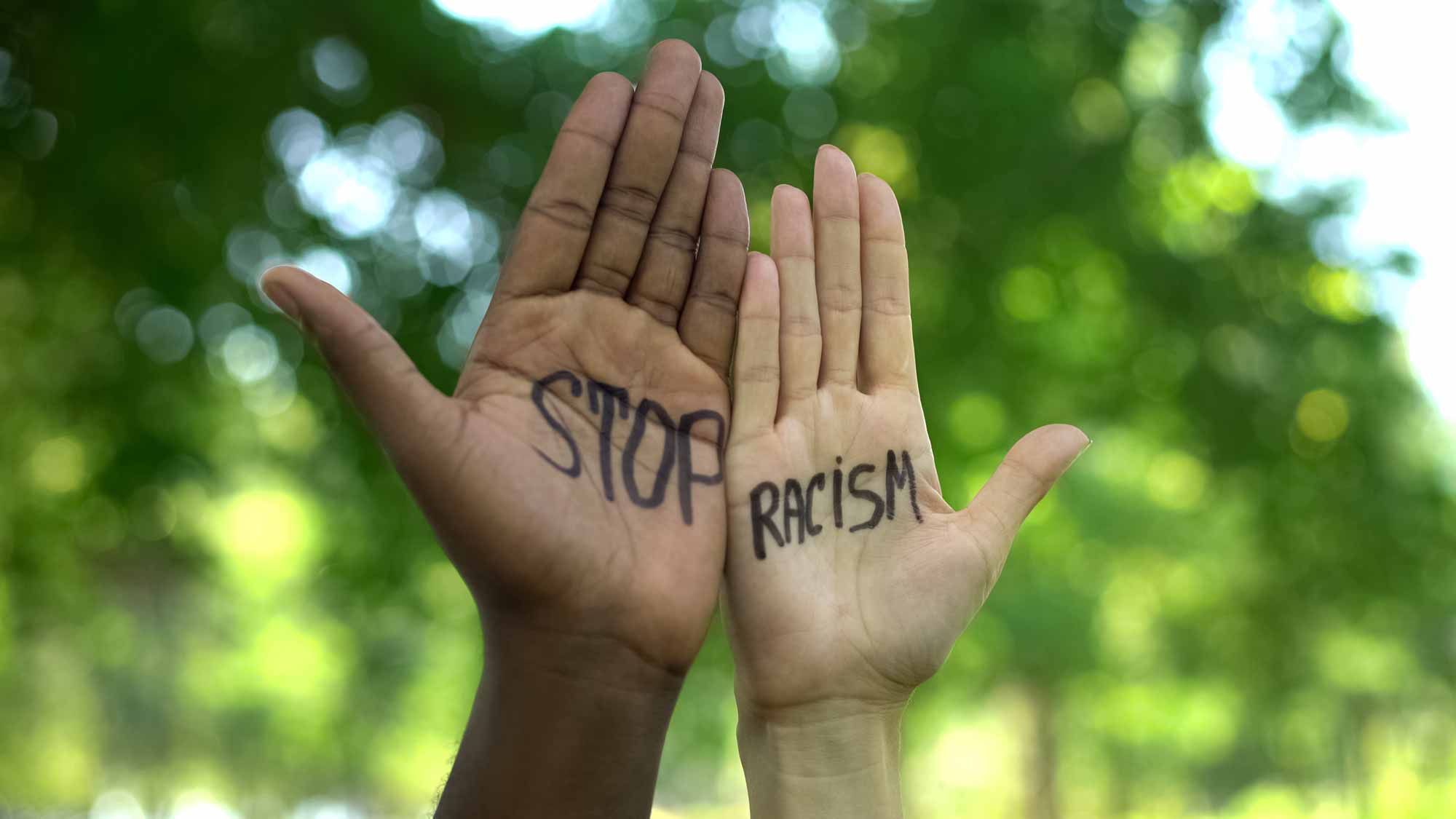 2 hands that reads Stop Racism